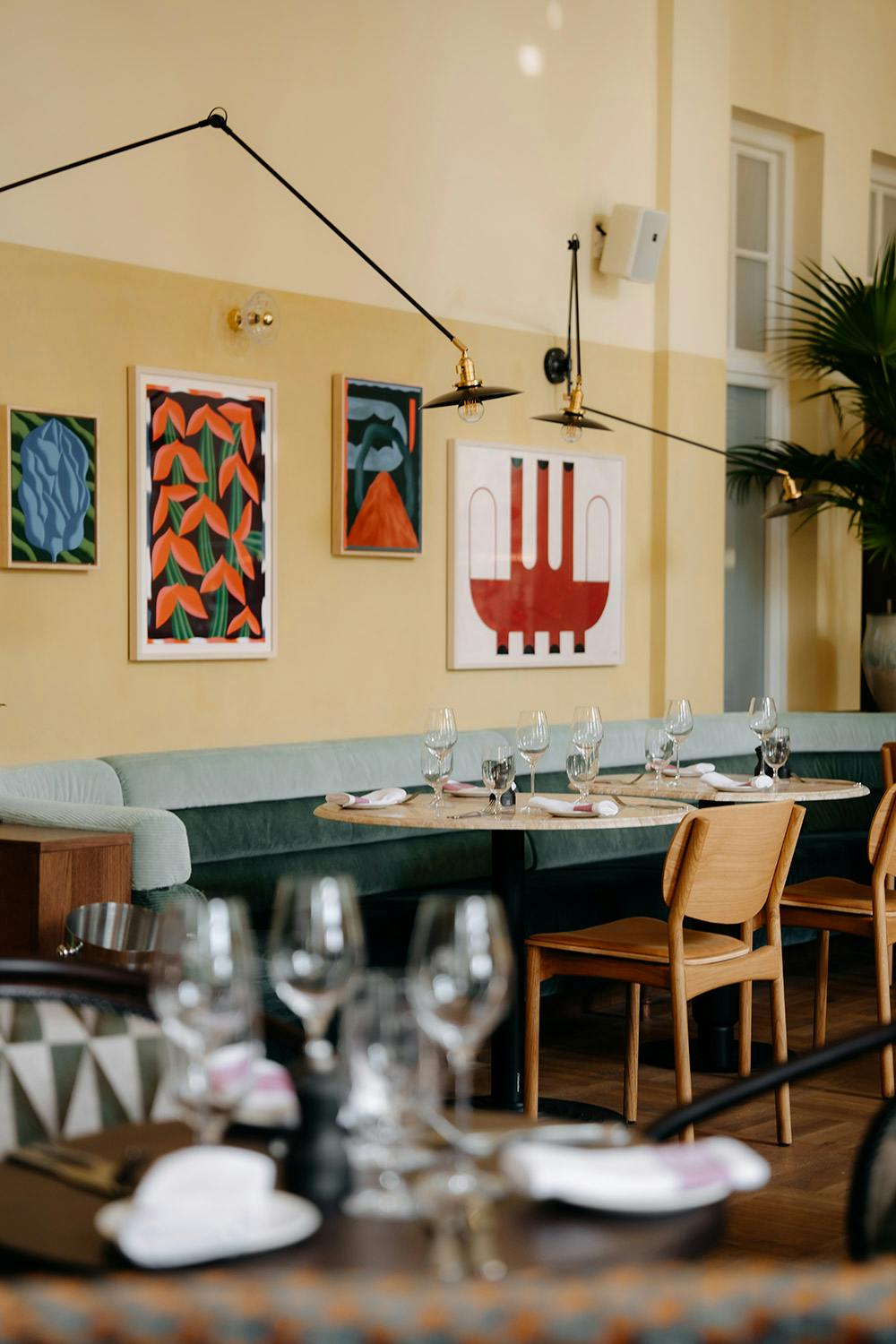 Art on the pastel walls above a table for three